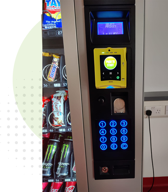 Contemporary vending machine with illuminated compartments, showcasing a mix of snacks and cold beverages